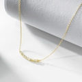 Elegant gold S925 silver necklace with baguette zircon smile pendant on a white marble stand - 925 Silver / Gold