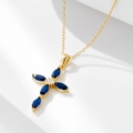 Elegant gold cross necklace featuring blue marquise stones and a clear zircon pendant - Gold
