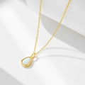 Macro shot of s925 silver pear-shaped opal pendant with elegant golden finish - 925 Silver / Gold