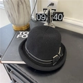 Elegant black knitted bucket hat with a contrast bow detail, shown in a stylish setup - 56-58cm / Black