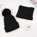 Detail of black cable-knit beanie with faux fur pom pom and matching neck gaiter - Hat And Scarf Set / Black