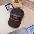 Deep brown washed cotton baseball cap with intricate embroidery on a wooden table - 56-58cm / Coffee
