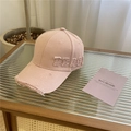 Light pink distressed baseball cap with PEACH embroidery on a glass tabletop - 57-62cm (Adjustable) / Pink