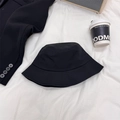 Classic black oversized bucket hat for men and women on a stylish minimalist background - 56-60cm / Black