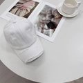 Distressed white cotton canvas baseball cap with vintage ripped details on a white table - 56-59cm (Adjustable) / White
