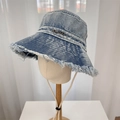 Snow-washed blue denim bucket hat with distressed frayed edges and metal plaque - 56-58cm / Light Blue