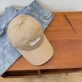 Khaki cotton baseball cap with white Concise 3D embroidery on a rustic wooden desk - Khaki