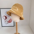 Beige woven straw bucket hat with white embroidery detail on a mannequin stand - 56-58cm / Camel