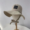 Green and pink checkered sun hat with black label and windproof strap on model stand - 56-58cm / Green and Pink