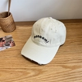 Distressed cream cotton baseball cap with monoomi letter embroidery on a wooden table - 56-58cm Adjustable / Beige