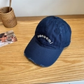 Navy blue baseball cap with distressed details and monoomi embroidery on a wooden table - 56-58cm Adjustable / Navy Blue