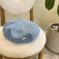 Light blue denim beret hat with metallic triangle badge on a cozy white chair - 55-59CM / Light Blue