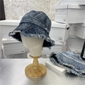 Dark blue washed denim bucket hat with frayed edges shown on a mannequin head - 56-58cm / Dark Blue