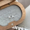Detail of triangle stud earrings in matte S925 silver on velvet in a wooden box - Triangle Style / 925 Silver