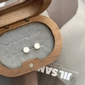 Minimalist geometric silver stud earrings showcased in a round wooden jewelry box - Geometric Polyhedron Style / 925 Silver