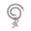 Macro shot of silver hip-hop necklace with pink rhinestone lip and letter K pendant - Silver Letter K