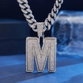 Macro shot of iced-out letter M pendant with diamonds on a thick silver Cuban link chain - Necklace (Silver Letter M) / Silver Letter M