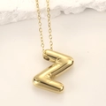 Detailed view of shiny gold balloon-style letter Z pendant with starburst engraving - Pendant + 20in Chain / Gold Letter Z