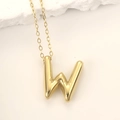 Polished golden stainless steel bubble letter W pendant necklace on a minimalist background - Gold Letter W