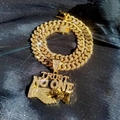 Macro shot of gold-plated iced-out Cuban chain and Trust No One pendant detail - Pendant + Cuban Chain / Gold Handshake Charm Necklace