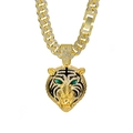 Macro detail of gold tiger pendant with clear crystals and green eyes on Cuban chain - Gold Tiger Head Necklace