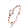 Dettaglio dell'anello a palline in oro rosa con una pietra di zircone centrale chiara - US 6 / Oro rosa