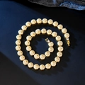 Detailed macro view of sparkling gold Cuban chain with iced-out round cubic zirconia links - Rope Necklace / Gold