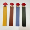 Detailed view of four colorful PU leather bookmarks with cute red mushroom tops - 15x2.4cm / Yellow