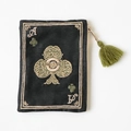 Detail of embroidered Ace of Clubs pattern on black fabric pouch with green tassel - Black