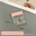 Detailed view of a small pink 7x8cm EVA jewelry storage bag sealing a gold ring - 7x8cm (50 Silk) Transparent