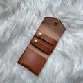 Detail of brown PU leather jewelry pouch showing interior ring holder and metal snaps - Brown (PU Leather)