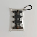 Macro detail of portable Japanese coin organizer with PVC cover and metal carabiner - Black