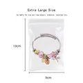 Extra large 13x9cm clear PVC jewelry storage bag holding a beaded charm bracelet - Single Jewelry Bag (9*13cm)
