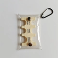 Macro detail of portable clear PVC coin holder with Japanese Yen denomination slots - Yellow
