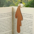 Creative spilled coffee bookmark made of brown PU leather placed inside an open book - Brown