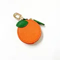 Detail der orangefarbenen PU-Leder-Geldbörse mit grünem Blatt und goldener Klammer - Orange