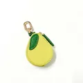 Close-up of lemon-shaped PU leather coin purse with green leaf detail and gold carabiner - Pear