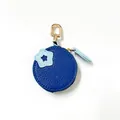 Detail of round navy blue PU leather coin purse with star patch and golden spring hook - Blueberry