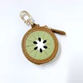 Detail of kiwi fruit coin purse made of brown PU leather with golden metal swivel clasp - Kiwi