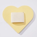 Close-up of heart-shaped yellow PU leather stylus holder with elastic strap detail - Milk Yellow