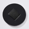 Close-up of a circular PU leather pen holder with a black elastic loop for notebooks - Black