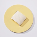 Detail view of round PU leather self-adhesive pen holder with white elastic loop strap - Milk Yellow