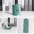 Detail view of mint leather cash wrap organizer with elastic band and bronze fastener - 22.5x7.7cm / Lake Blue