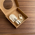 Close-up of contact lens applicator kit with cream leather case and metal carabiner hook - Hook Style / White
