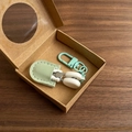 Detail view of mint green mini precision scissors in leather case with carabiner hook - Hook Style / Green