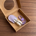 Detailed view of mini precision scissors in purple leather sheath with metal snap hook - Hook Style / Purple