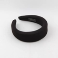 Detailed shot of thick black sponge headband featuring a woven HAND MADE interior label - Black