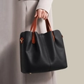 Large capacity black pebble leather tote bag with orange handles and gold hardware details - Black