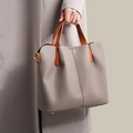 Chic greige pebbled leather tote bag with orange brown handles and gold hardware accents - Khaki