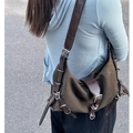 Deep olive green vintage messenger bag with silver buckles and leather trim on model - Coffee Brown